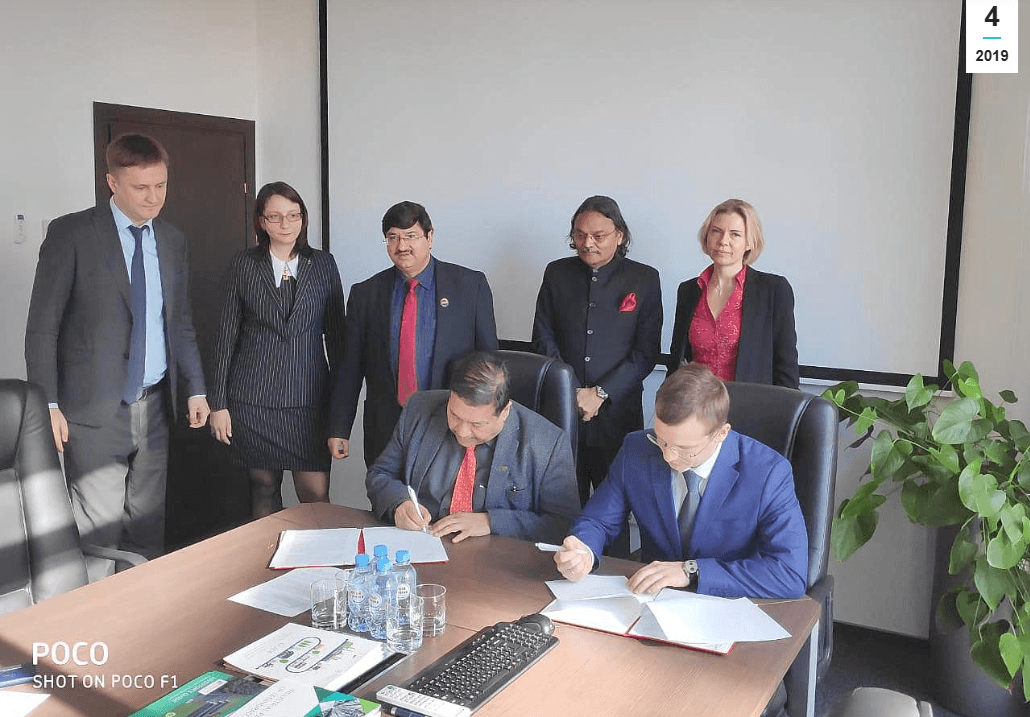 IICCI MoU signing ceremony with executives signing documents at conference table